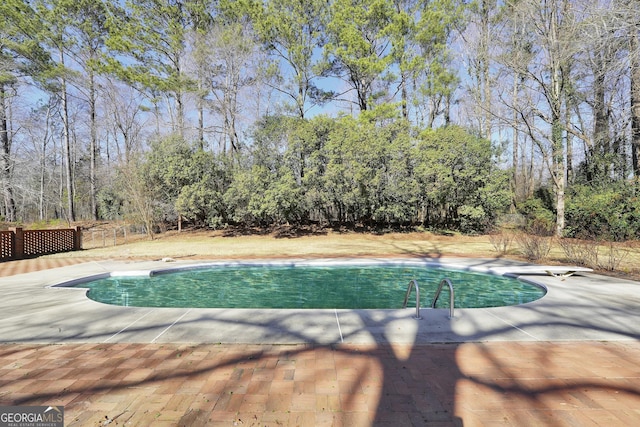 105 Skyline Dr, Barnesville, GA 30204 - outdoor pool with fence, a diving board, and a patio