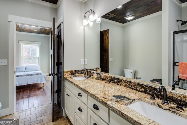 full bathroom with ensuite bathroom, a sink, visible vents, and crown molding