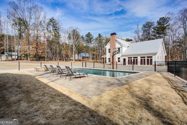 view of swimming pool featuring fence, a fenced in pool, and a patio