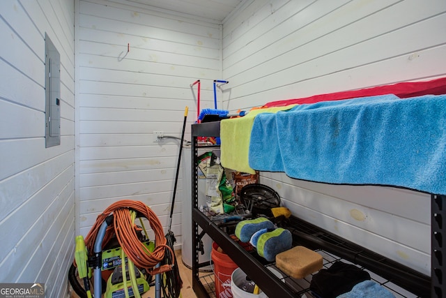 interior space featuring electric panel and wood walls