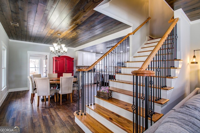 dining area featuring dark wood-style flooring, crown molding, visible vents, wood ceiling, and stairs