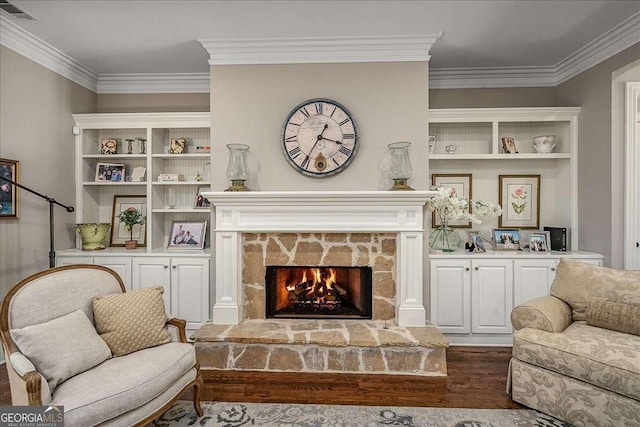 living area featuring ornamental molding, a stone fireplace, and dark hardwood / wood-style floors