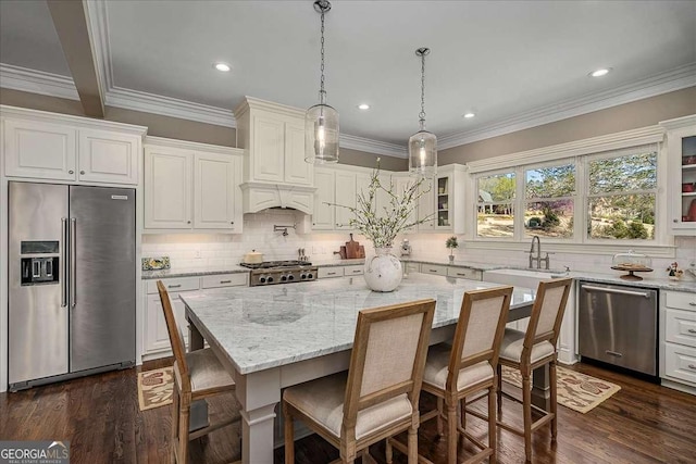 kitchen featuring stainless steel appliances, backsplash, a sink, premium range hood, and glass insert cabinets