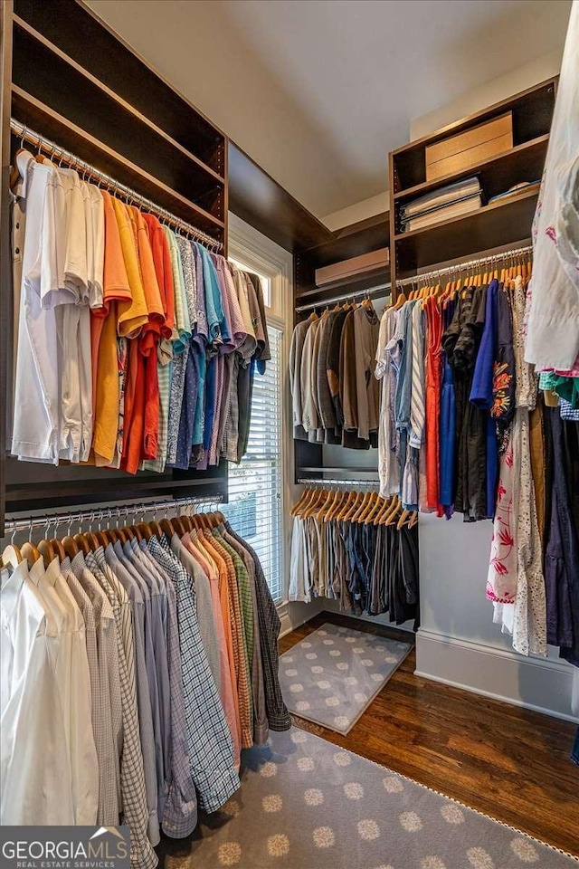 walk in closet featuring dark wood-type flooring