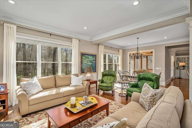 living room with baseboards, wood finished floors, recessed lighting, and a chandelier