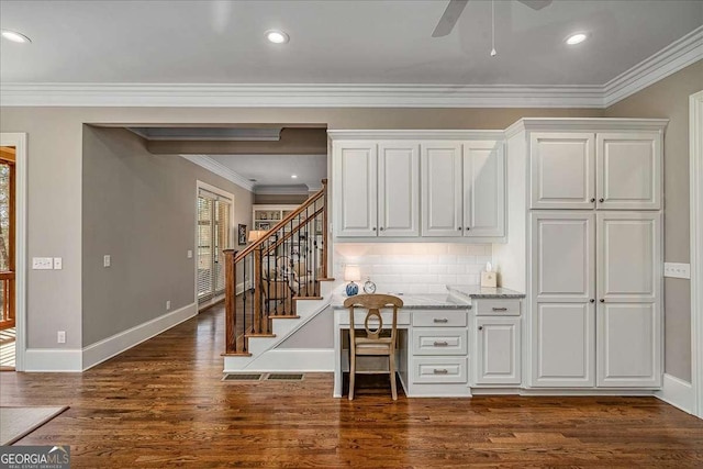 kitchen featuring crown molding, plenty of natural light, white cabinets, and dark hardwood / wood-style flooring