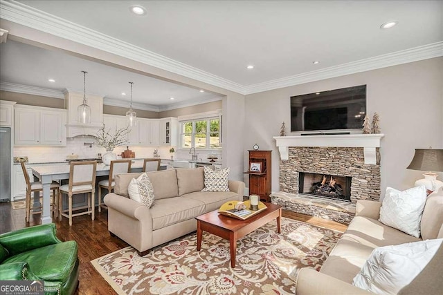 living room featuring crown molding, a stone fireplace, and dark hardwood / wood-style floors