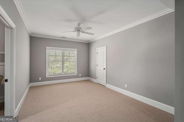 carpeted empty room with crown molding and ceiling fan