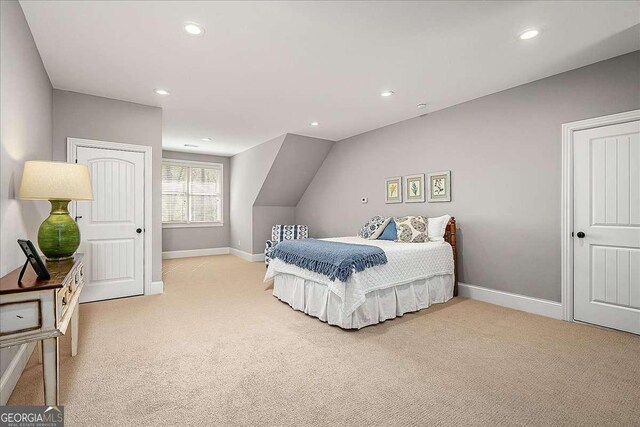 carpeted bedroom featuring baseboards and recessed lighting