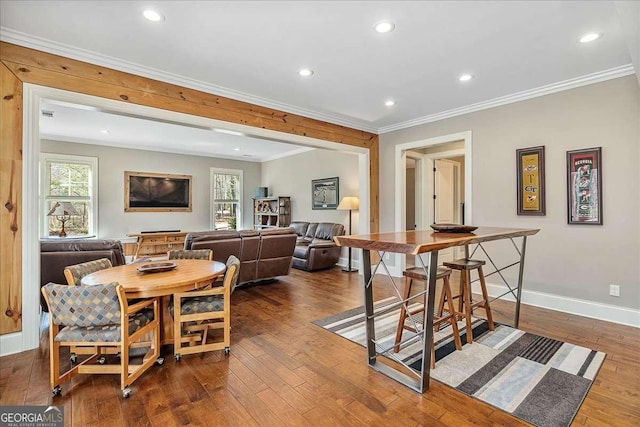 dining space with recessed lighting, dark wood finished floors, baseboards, and ornamental molding