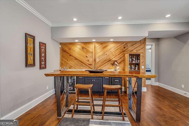 bar featuring dark wood-type flooring and ornamental molding