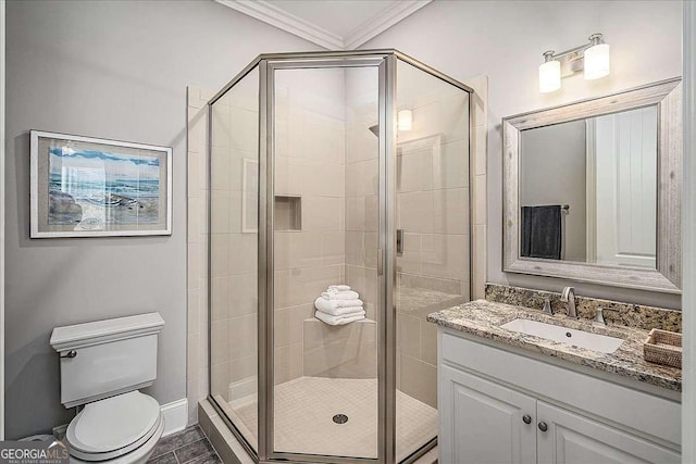 bathroom with crown molding, vanity, an enclosed shower, and toilet