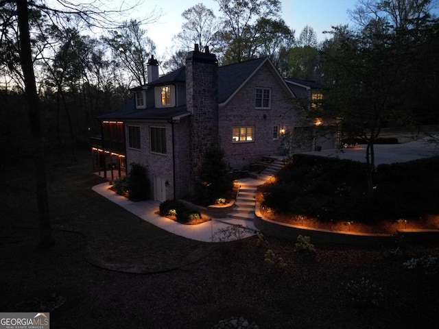 view of back house at dusk