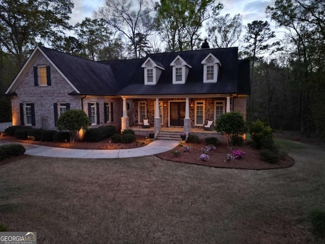 cape cod-style house with a porch