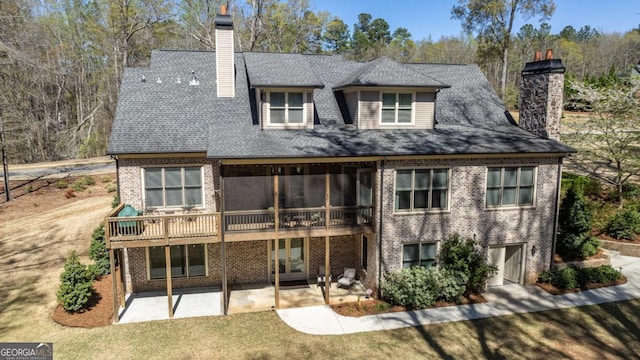 rear view of house with a patio area and a lawn