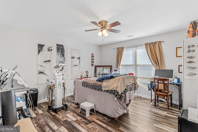 bedroom featuring hardwood / wood-style flooring and ceiling fan