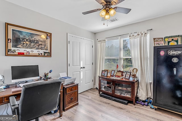 office with ceiling fan and light hardwood / wood-style floors