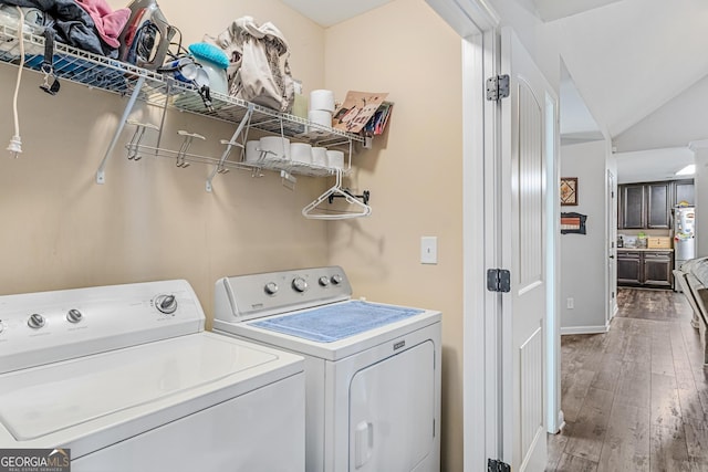 washroom featuring dark hardwood / wood-style floors and washer and dryer