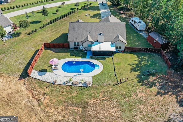 view of swimming pool featuring a shed