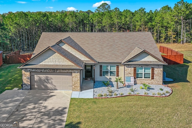 craftsman house with a garage and a front lawn