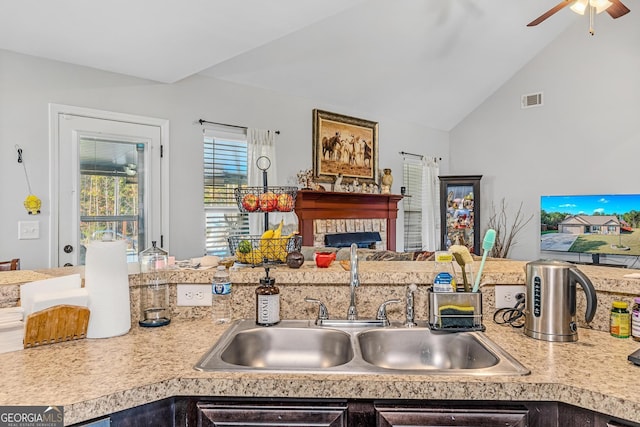 kitchen featuring sink, vaulted ceiling, and ceiling fan