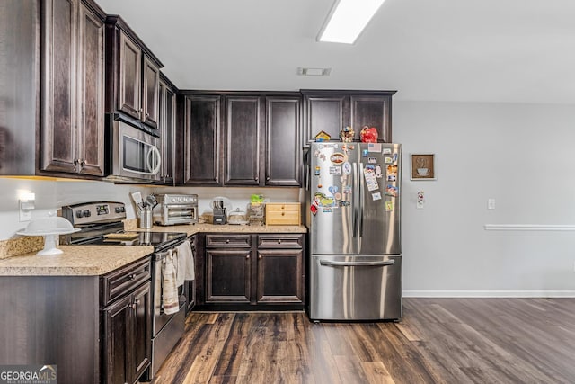 kitchen with dark brown cabinets, stainless steel appliances, and dark hardwood / wood-style floors