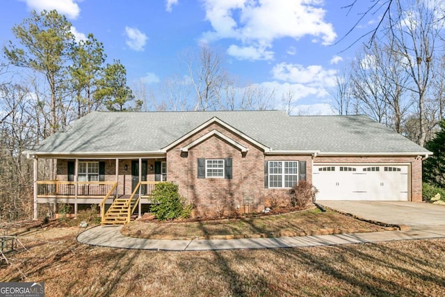 ranch-style house with a garage and covered porch