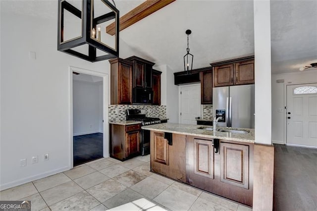 kitchen with decorative light fixtures, tasteful backsplash, sink, a breakfast bar area, and stainless steel appliances