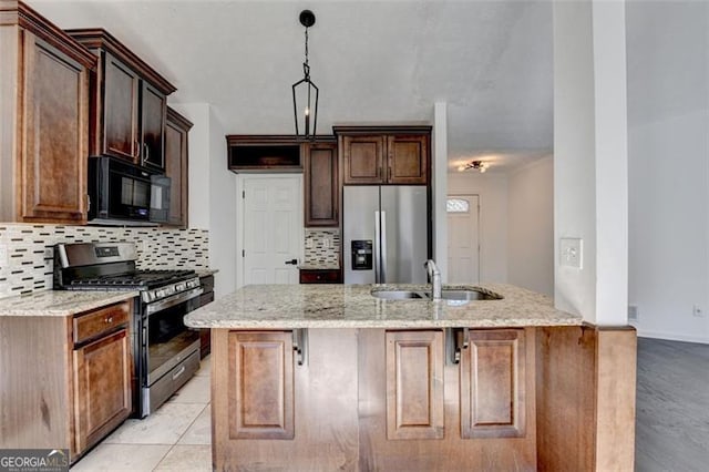 kitchen featuring light stone counters, sink, tasteful backsplash, and stainless steel appliances