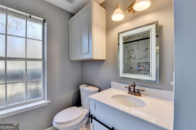 bathroom featuring vanity and toilet