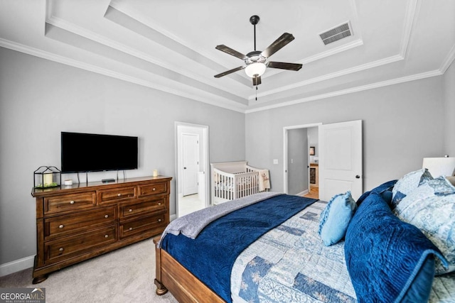 carpeted bedroom with crown molding, a raised ceiling, and ceiling fan