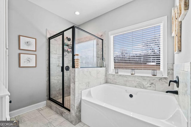 bathroom featuring shower with separate bathtub