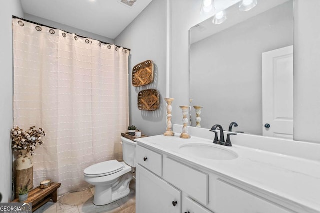 bathroom featuring vanity and toilet