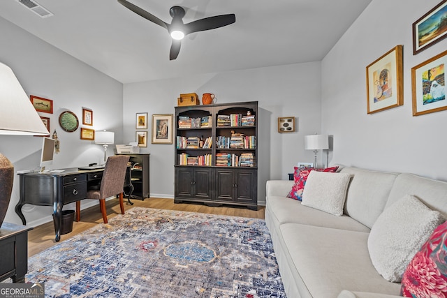 home office with ceiling fan and light hardwood / wood-style floors