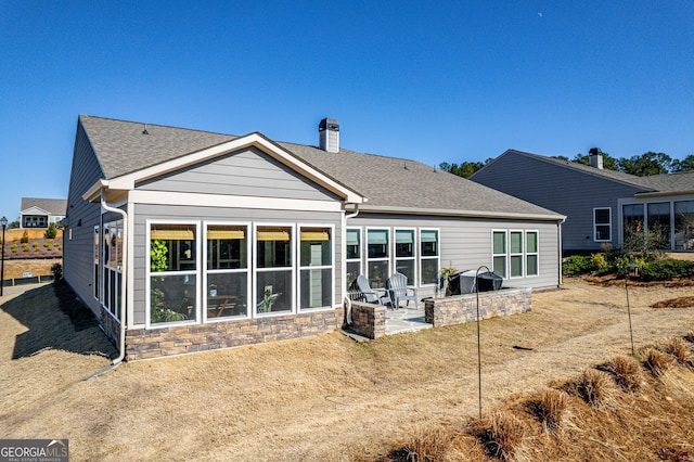 back of house with a lawn and a patio