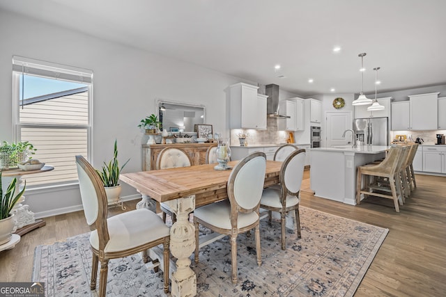 dining area featuring sink and light hardwood / wood-style floors