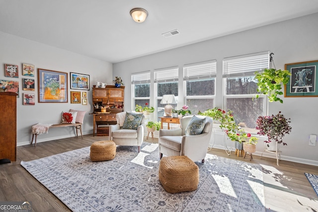 sitting room with dark wood-type flooring