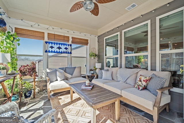 sunroom / solarium featuring ceiling fan