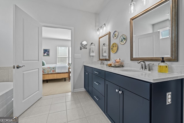 bathroom featuring plenty of natural light, tile patterned flooring, vanity, and a washtub