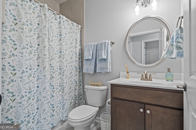 bathroom with vanity, curtained shower, and toilet