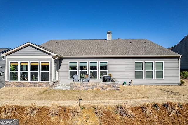 rear view of property featuring a patio area and a lawn