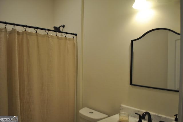 bathroom with sink, a shower with curtain, and toilet