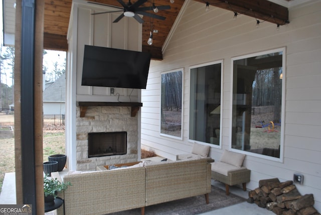 view of patio featuring ceiling fan and an outdoor stone fireplace