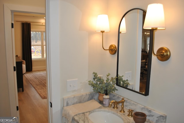 bathroom featuring hardwood / wood-style flooring and vanity