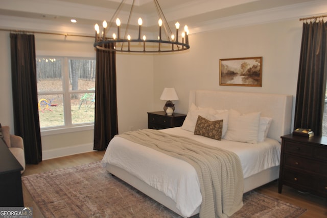 bedroom featuring crown molding and wood-type flooring