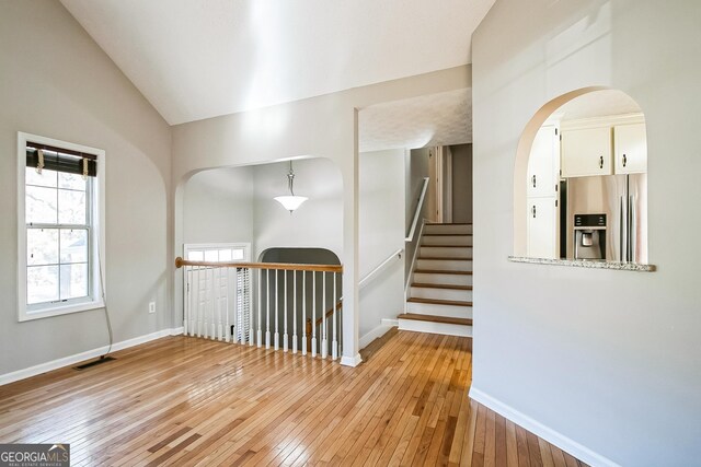 interior space with vaulted ceiling and light wood-type flooring