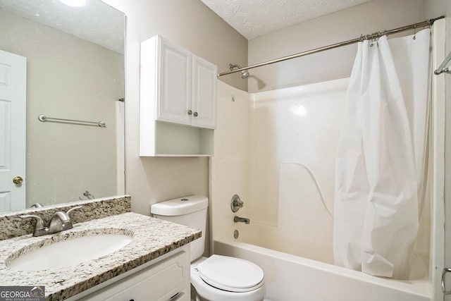 full bathroom featuring vanity, toilet, a textured ceiling, and shower / bath combo with shower curtain