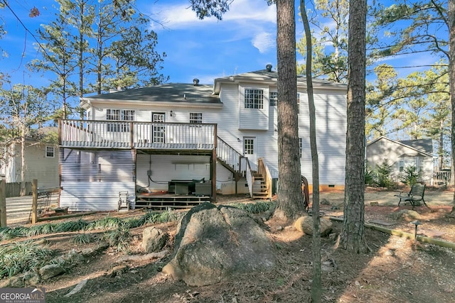 rear view of property featuring a wooden deck