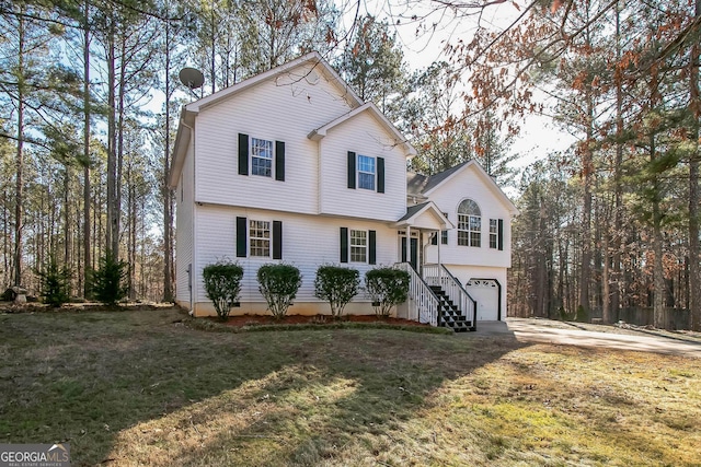 view of property featuring a garage and a front lawn