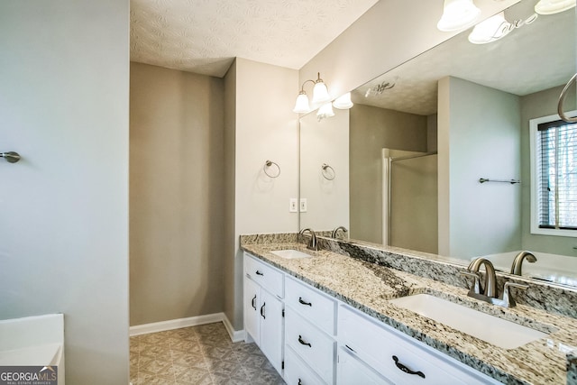 bathroom featuring vanity, a textured ceiling, and walk in shower